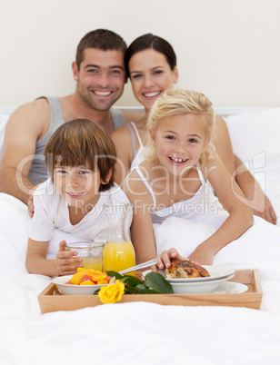 Family having breakfast in bedroom