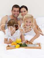 Family having breakfast in bedroom