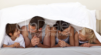 Family talking under the sheets