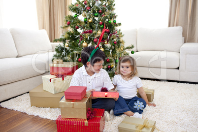 Happy children celebrating Christmas at home