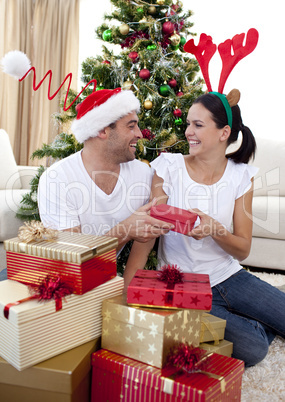 Happy couple giving presents for Christmas