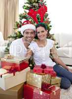 Happy couple celebrating Christmas at home