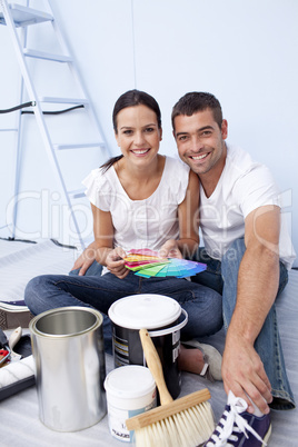 Couple with colour samples to paint new appartment