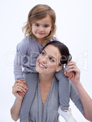 Smiling mother giving her daughter piggyback ride
