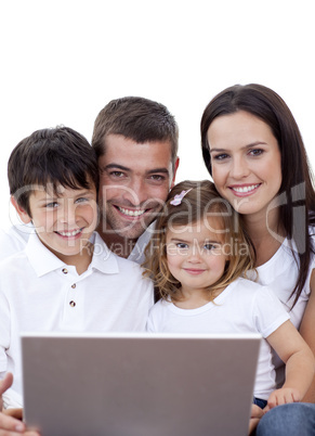 Portrait of young family using a laptop at home