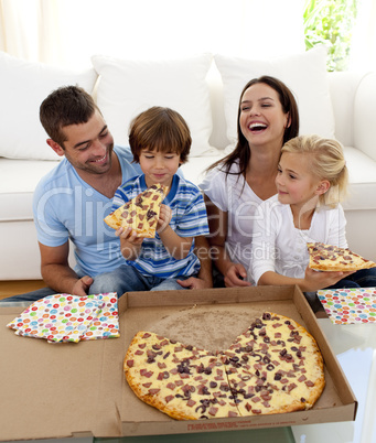 Parents and children eating pizza in living-room