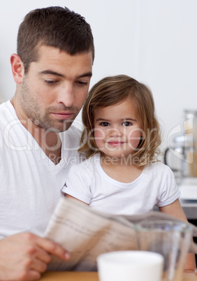 Father reading a newspaper with his daughter