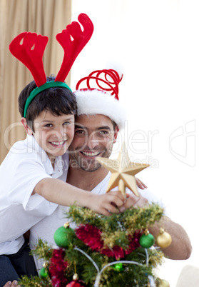 Father and son decorating Christmas tree