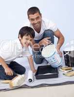 Father and son painting a room