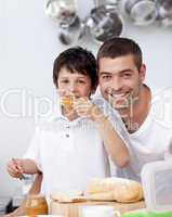 Father and son eating a toast