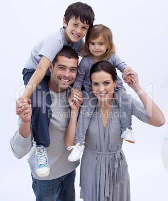 Parents giving children piggyback rides