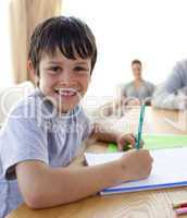 Boy painting with colourful colours at home