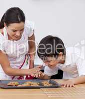 Mother and son baking biscuits in the kitchen
