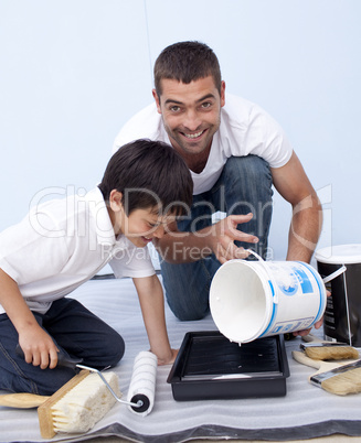 Father and son painting a bedroom