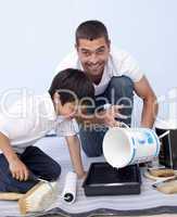 Father and son painting a bedroom