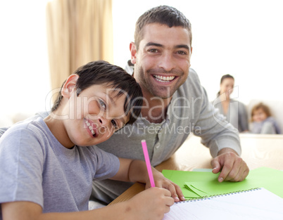 Boy painting with his father at home