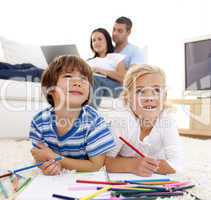 Children painting in living-room and parents on sofa