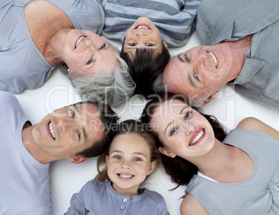 High angle of family lying on floor with heads together