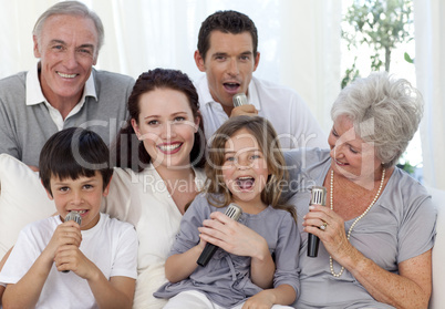 Family singing karaoke in living-room