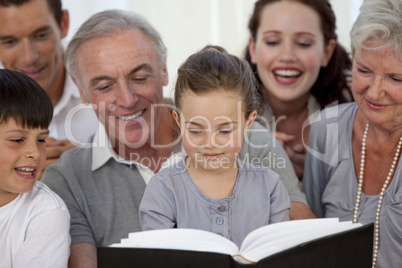 Close-up of family looking at a photograph album
