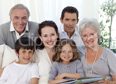 Portrait of family looking at a photograph album