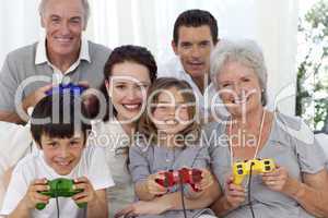 Grandparents, parents and children playing video games