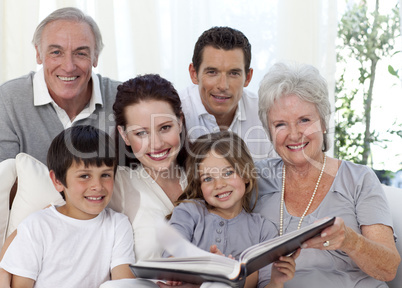 Smiling family looking at a photograph album