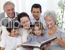 Family reading a book in living-room
