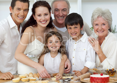 Portrait of parents, grandparents and children baking in the kit