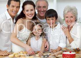 Portrait of parents, grandparents and children baking in the kit