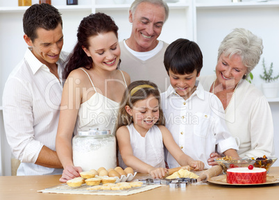 Parents and granparents looking at children baking