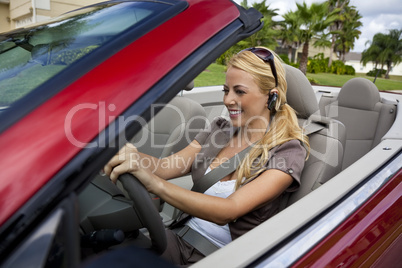 Beautiful Young Woman Driving Convertible Car Talking on Bluetoo