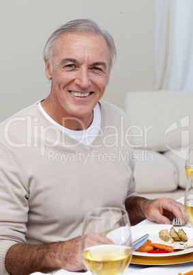 Senior man eating turkey in Christmas dinner
