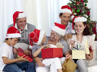 Family opening Christmas presents at home