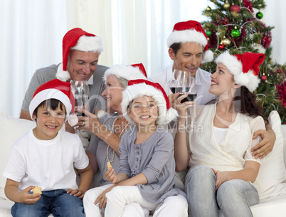 Family celebrating Christmas with wine and sweets at home