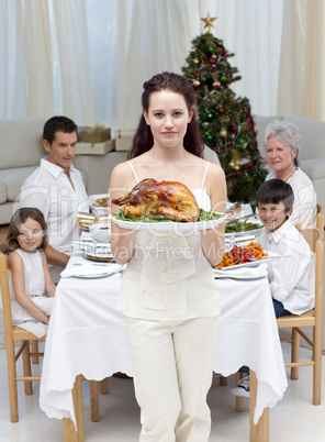 Mother showing turkey for Christmas dinner