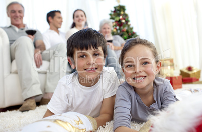 Smiling children looking for presents in Christmas boots