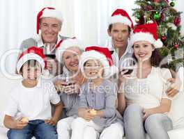 Family celebrating Christmas with wine and sweets