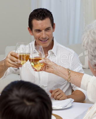 Man toasting with his mother in a Christmas dinner