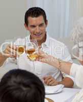 Man toasting with his mother in a Christmas dinner