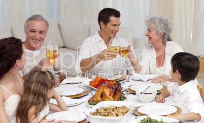 Parents and grandparents tusting with wine in a dinner