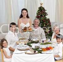 Family celebrating Christmas dinner with turkey
