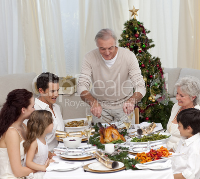 Family having Christmas dinner eating turkey