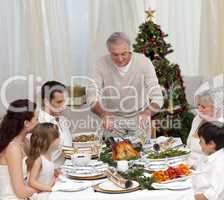 Family having Christmas dinner eating turkey