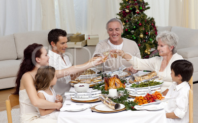 Family tusting in a Christmas dinner