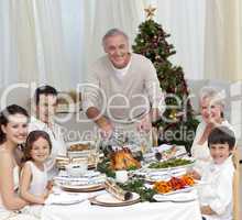 Grandfather cutting turkey for Christmas dinner