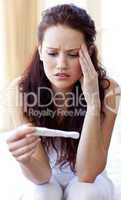 Woman looking at a pregnancy test