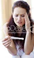 Woman looking at a pregnancy test