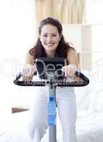 Woman doing spinning bike at home