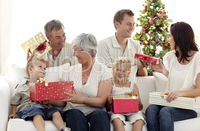 Family opening Christmas gifts at home